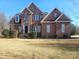 Traditional two-story brick home featuring a well-manicured lawn and a classic architectural design at 159 S Gibbs Rd, Mooresville, NC 28117