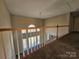 Hallway looking down to the first floor, with carpeted floors and wooden railing at 159 S Gibbs Rd, Mooresville, NC 28117
