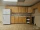 Kitchen features wooden cabinets, refrigerator, sink, and countertops at 159 S Gibbs Rd, Mooresville, NC 28117