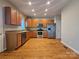 A well-lit kitchen featuring stainless steel appliances, granite countertops, and hardwood floors at 159 S Gibbs Rd, Mooresville, NC 28117