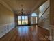 Open-concept living room featuring hardwood floors, chandelier, and stairway to upper level at 159 S Gibbs Rd, Mooresville, NC 28117