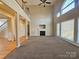 Spacious living room with a fireplace, carpeted floors, and plenty of natural light from large windows at 159 S Gibbs Rd, Mooresville, NC 28117