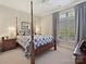 Bedroom featuring a four poster bed, soft lighting, and large window at 1918 Ealand Ct, Waxhaw, NC 28173