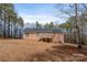 Brick home with a black shingle roof, wooden deck, and stairs in a tree-filled yard at 201 Olive Rd, Stony Point, NC 28678