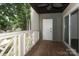 Balcony featuring wood floors, decorative railing, a white entry door and sliding glass doors at 20115 Henderson Rd # D, Cornelius, NC 28031