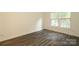 The spacious bedroom features wood-look flooring and a large window for plenty of natural light at 20115 Henderson Rd # D, Cornelius, NC 28031