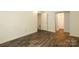 Spacious bedroom with wood-look floors and a glimpse into the closet and hallway at 20115 Henderson Rd # D, Cornelius, NC 28031