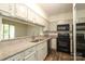 Bright kitchen with granite countertops, stainless steel appliances, and a passthrough to another room at 20115 Henderson Rd # D, Cornelius, NC 28031