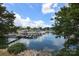 Picturesque view of a serene lake with boats docked, framed by lush greenery at 20115 Henderson Rd # D, Cornelius, NC 28031