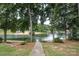 Inviting lake view of a lakeside community and sandy beach, framed by mature trees at 20115 Henderson Rd # D, Cornelius, NC 28031