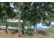 Lake view featuring lush trees, sandy beach and pier at 20115 Henderson Rd # D, Cornelius, NC 28031