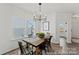 Bright dining area with modern light fixture, wood table, and large window for ample natural light at 205 Tillery Ln # 759, Mount Gilead, NC 27306