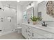 Modern bathroom featuring double vanity, sleek fixtures, and a glass-enclosed shower with subway tile at 209 Tillery Ln # 758, Mount Gilead, NC 27306