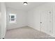 Bright bedroom with a large window, neutral carpet, and a convenient closet for comfortable living at 209 Tillery Ln # 758, Mount Gilead, NC 27306