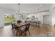Kitchen and dining area featuring quartz counters, island with seating, and modern fixtures at 209 Tillery Ln # 758, Mount Gilead, NC 27306