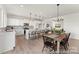 Kitchen and dining area featuring quartz counters, island with seating, and modern fixtures at 209 Tillery Ln # 758, Mount Gilead, NC 27306