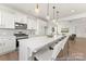 Open kitchen with a large island, stainless appliances, and seamless flow into the living area at 209 Tillery Ln # 758, Mount Gilead, NC 27306