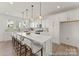Modern kitchen with stainless steel appliances, quartz countertops, and an island with bar seating at 209 Tillery Ln # 758, Mount Gilead, NC 27306