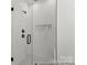 Detailed view of the luxurious glass enclosed walk-in shower featuring white subway tile and black fixtures at 209 Tillery Ln # 758, Mount Gilead, NC 27306