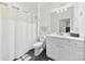 Well-lit bathroom with a shower-tub combination, a white sink vanity with storage, and a white toilet at 215 Lytton Farm Rd, Troutman, NC 28166