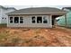 Back view of home shows siding and windows. 