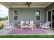 Relaxing back porch seating area with an outdoor sofa, chairs, a rug, and a ceiling fan for comfort at 2210 Camber Dr # Cwo0075, Gastonia, NC 28054