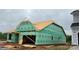 Exterior view of a home under construction with green weather-resistant barriers and an unfinished roof at 2210 Camber Dr # Cwo0075, Gastonia, NC 28054
