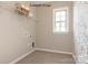 Bright laundry room featuring a window for natural light, tile floors, storage shelf, and appliance connections at 2210 Camber Dr # Cwo0075, Gastonia, NC 28054