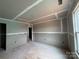 Unfinished living room has freshly taped drywall, window, and doorway at 2210 Camber Dr # Cwo0075, Gastonia, NC 28054