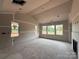 Living room under construction with a fireplace, bare walls and floors, and large windows at 2210 Camber Dr # Cwo0075, Gastonia, NC 28054