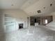 Unfinished living room featuring fireplace, built-in shelves, and view of the kitchen in a new home at 2210 Camber Dr # Cwo0075, Gastonia, NC 28054