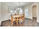 Formal dining room with hardwood floors, wainscoting, stylish lighting, and a large table at 2314 Talon Point Cir, Fort Mill, SC 29715