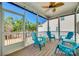 Cozy screened-in porch with a ceiling fan, wood flooring, and charming blue seating, perfect for outdoor relaxation at 2314 Talon Point Cir, Fort Mill, SC 29715