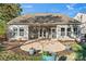 Backyard with a concrete patio, gray siding, a screened porch, and verdant landscaping at 2439 Bergamot St, Fort Mill, SC 29708