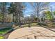 Fenced backyard with a spacious patio, terraced landscaping, and a serene wooded backdrop at 2439 Bergamot St, Fort Mill, SC 29708
