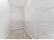 Walk-in closet with white wire shelving and neutral carpeting offers ample storage space at 2439 Bergamot St, Fort Mill, SC 29708