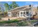 Exterior view of a home with a screened-in porch and patio in a lush backyard at 2439 Bergamot St, Fort Mill, SC 29708