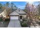 Beautiful brick home with a two-car garage, complemented by mature trees at 2439 Bergamot St, Fort Mill, SC 29708