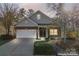 Inviting brick home featuring a two-car garage and well-lit walkway at 2439 Bergamot St, Fort Mill, SC 29708