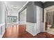 Hallway featuring hardwood floors, gray walls, and decorative white trim at 2439 Bergamot St, Fort Mill, SC 29708