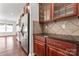 Kitchen featuring stainless steel appliances, granite countertops, and rich wooden cabinetry at 2439 Bergamot St, Fort Mill, SC 29708