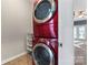 Convenient laundry area featuring a stacked washer and dryer set plus additional shelving space at 2439 Bergamot St, Fort Mill, SC 29708