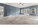 Bright living room with a ceiling fan, windows, and carpet floors at 2439 Bergamot St, Fort Mill, SC 29708