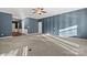 Spacious living room with modern ceiling fan, plush carpet, and natural light at 2439 Bergamot St, Fort Mill, SC 29708