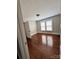 Neutral bedroom featuring hardwood floors, two large windows, and classic trim, offering a cozy and inviting atmosphere at 2507 Florida Ave, Kannapolis, NC 28083