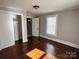 Bedroom showcasing gleaming hardwood floors, a window with blinds, and a closet for storage at 2507 Florida Ave, Kannapolis, NC 28083