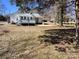 Exterior view of the home with a spacious yard and gray painted deck at 2507 Florida Ave, Kannapolis, NC 28083
