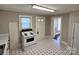 Kitchen view featuring white appliances, black and white flooring and plentiful natural light at 2507 Florida Ave, Kannapolis, NC 28083