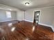 Bright living room featuring hardwood floors, neutral paint, and a seamless transition to the adjacent carpeted area at 2507 Florida Ave, Kannapolis, NC 28083