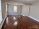 Cozy living area with hardwood floors, neutral paint, and an open layout with large windows and lots of natural light at 2507 Florida Ave, Kannapolis, NC 28083